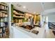 Open kitchen with stainless steel appliances, custom cabinets, a kitchen island, open shelves, and a bookcase at 587 Virginia Ne Ave # 314, Atlanta, GA 30306