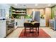Modern kitchen featuring stainless steel appliances, custom cabinets, a drop leaf table, and green accent wall at 587 Virginia Ne Ave # 314, Atlanta, GA 30306