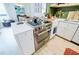 Contemporary kitchen with stainless steel oven and cooktop, white cabinetry, and white countertops at 587 Virginia Ne Ave # 314, Atlanta, GA 30306