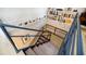Unique staircase with blue railings, complemented by a built-in bookshelf and framed photos on the wall at 587 Virginia Ne Ave # 314, Atlanta, GA 30306