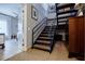 Interior staircase with metal railings, hardwood steps, and a unique shelving unit, adding character at 587 Virginia Ne Ave # 314, Atlanta, GA 30306