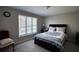 Relaxing bedroom featuring a large window, soft lighting, and comfortable furnishings at 610 Loth Wages Rd, Dacula, GA 30019