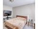 Neutral bedroom features a queen bed, TV on stand, side table, and cozy carpet flooring at 610 Loth Wages Rd, Dacula, GA 30019