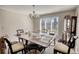This dining room features neutral tones, large window, and traditional-style furniture at 610 Loth Wages Rd, Dacula, GA 30019
