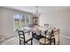 Dining room area features a large window, chandelier, and traditional-style furniture at 610 Loth Wages Rd, Dacula, GA 30019