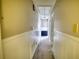 Hallway with neutral paint, white wainscoting, carpet and access to multiple rooms at 610 Loth Wages Rd, Dacula, GA 30019