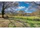 Picture of pasture land with fenced boundary and storage building in the background at 610 Loth Wages Rd, Dacula, GA 30019