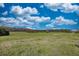 Expansive property features lush, rolling pasture land set against a partly cloudy blue sky at 610 Loth Wages Rd, Dacula, GA 30019