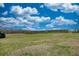 Photo of property with rolling pasture land and treeline against partly cloudy blue sky at 610 Loth Wages Rd, Dacula, GA 30019