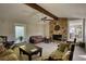 Spacious living room with stone fireplace, carpet flooring, and access to the sunroom at 610 Loth Wages Rd, Dacula, GA 30019
