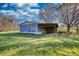 Outbuilding features large open bay and room for equipment storage on grassy property at 610 Loth Wages Rd, Dacula, GA 30019