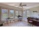 Bright sunroom with lots of windows, tile flooring, and a piano at 610 Loth Wages Rd, Dacula, GA 30019
