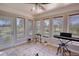 Bright sunroom with neutral tones, tile flooring, and lots of natural light from the surrounding windows at 610 Loth Wages Rd, Dacula, GA 30019