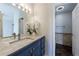 Bathroom vanity features double sinks, granite countertops, and overhead lighting at 2161 Peachtree Ne Rd # 907, Atlanta, GA 30309
