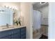 Bathroom with a large vanity, granite countertops, and a shower with curtain at 2161 Peachtree Ne Rd # 907, Atlanta, GA 30309