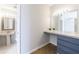 Bathroom featuring vanity with marble countertop, framed mirror, and a pedestal sink at 2161 Peachtree Ne Rd # 907, Atlanta, GA 30309