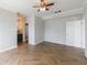 Large bedroom with herringbone floors, gray walls, and attached bath at 2161 Peachtree Ne Rd # 907, Atlanta, GA 30309