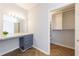 Walk-in closet and vanity with drawers and marble countertop, in bedroom at 2161 Peachtree Ne Rd # 907, Atlanta, GA 30309
