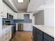 Charming kitchen features an island, stainless steel appliances, white cabinets, and wood floors at 2161 Peachtree Ne Rd # 907, Atlanta, GA 30309