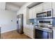 Modern kitchen with stainless steel appliances, white cabinetry, and stylish backsplash at 2161 Peachtree Ne Rd # 907, Atlanta, GA 30309
