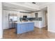Modern kitchen showcasing white cabinets, stainless steel appliances, and a blue center island at 2161 Peachtree Ne Rd # 907, Atlanta, GA 30309