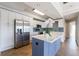 Well-lit kitchen with stainless steel appliances, white cabinets, and a blue island with a marble top at 2161 Peachtree Ne Rd # 907, Atlanta, GA 30309