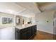 Open concept room with wood floors, large island, and beautiful city views at 2161 Peachtree Ne Rd # 907, Atlanta, GA 30309