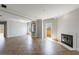 Living room featuring herringbone floors, fireplace, and access to a private balcony at 2161 Peachtree Ne Rd # 907, Atlanta, GA 30309
