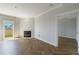 Bright living room features a fireplace, balcony access, and gorgeous herringbone floors at 2161 Peachtree Ne Rd # 907, Atlanta, GA 30309
