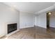 Living room area with light grey walls, a fireplace, and beautiful herringbone flooring at 2161 Peachtree Ne Rd # 907, Atlanta, GA 30309