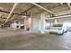 Well-lit parking garage with painted support columns and parking for residents at 2161 Peachtree Ne Rd # 907, Atlanta, GA 30309