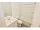 Bright, clean bathroom featuring a white vanity, toilet, and shower-tub combo with sliding glass doors at 4209 Tifton Ln, Sugar Hill, GA 30518