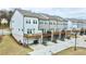 New townhouse construction with attached garages, rear decks, and manicured lawns in a vibrant community at 4209 Tifton Ln, Sugar Hill, GA 30518