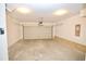 Clean, open garage with a modern automatic door, ready for parking or storage, featuring smooth concrete floors at 4209 Tifton Ln, Sugar Hill, GA 30518