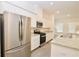 Modern kitchen with stainless steel appliances, granite countertops, and white cabinets, lots of light at 4209 Tifton Ln, Sugar Hill, GA 30518