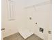 Well lit laundry room with modern flooring and white walls at 4209 Tifton Ln, Sugar Hill, GA 30518