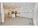 Bright open-concept living room with modern wood flooring, kitchen island, and large windows at 4209 Tifton Ln, Sugar Hill, GA 30518