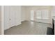 Modern living room with wood-look floors, a fireplace, and an open layout connected to the kitchen at 4209 Tifton Ln, Sugar Hill, GA 30518
