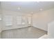 Open-concept living room with hardwood floors, white walls, large windows, and recessed lighting at 4209 Tifton Ln, Sugar Hill, GA 30518