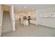 Open-concept living room featuring stairs, an island kitchen, wood-look floors, and natural light at 4209 Tifton Ln, Sugar Hill, GA 30518