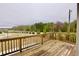 Open-air wooden deck showcasing serene views with natural landscaping, ideal for outdoor enjoyment at 4209 Tifton Ln, Sugar Hill, GA 30518