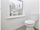 A pristine white toilet is situated near a window in the bathroom at 4209 Tifton Ln, Sugar Hill, GA 30518