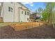 Spacious backyard showing layered retaining walls, and partial view of the house exterior at 5485 Woodrun Ln, Johns Creek, GA 30005