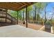 Backyard patio features a wooden deck, landscaping, and wooded views at 5485 Woodrun Ln, Johns Creek, GA 30005