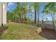 Landscaped backyard featuring a manicured lawn, a wooden fence and retaining walls at 5485 Woodrun Ln, Johns Creek, GA 30005