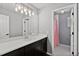 Modern bathroom featuring a sleek vanity with a large mirror and updated lighting at 5485 Woodrun Ln, Johns Creek, GA 30005