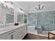 Luxurious bathroom with double vanities, a soaking tub, and a glass-enclosed shower at 5485 Woodrun Ln, Johns Creek, GA 30005