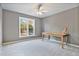 Carpeted bedroom with ceiling fan, natural light, and writing desk at 5485 Woodrun Ln, Johns Creek, GA 30005