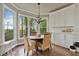 Breakfast nook with bay windows, natural light, and custom cabinets at 5485 Woodrun Ln, Johns Creek, GA 30005
