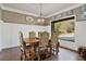 Elegant dining room with wainscoting, decorative plates and a large window at 5485 Woodrun Ln, Johns Creek, GA 30005